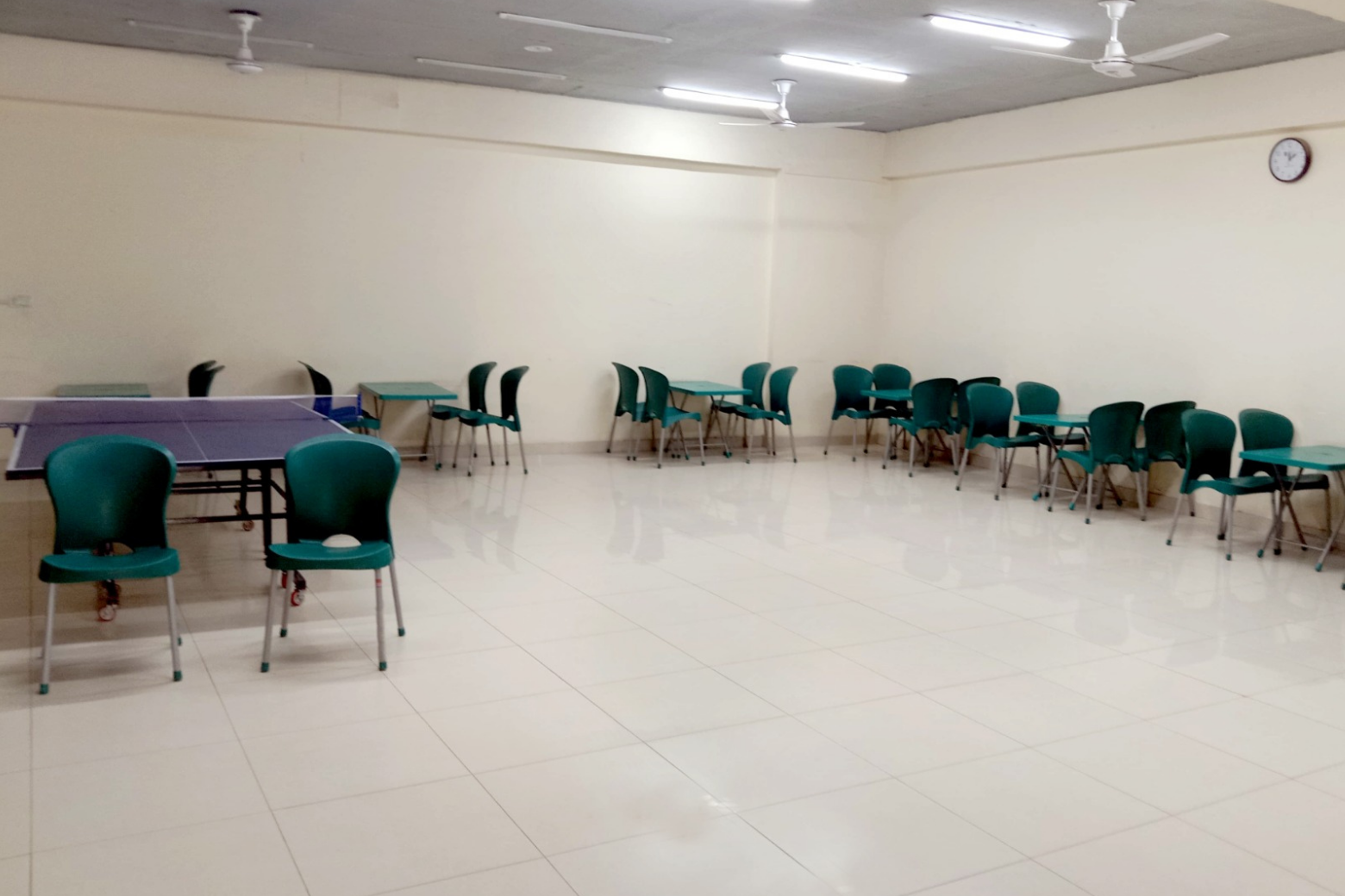 Cafeteria setup with seats aligned for meal service or student gathering.