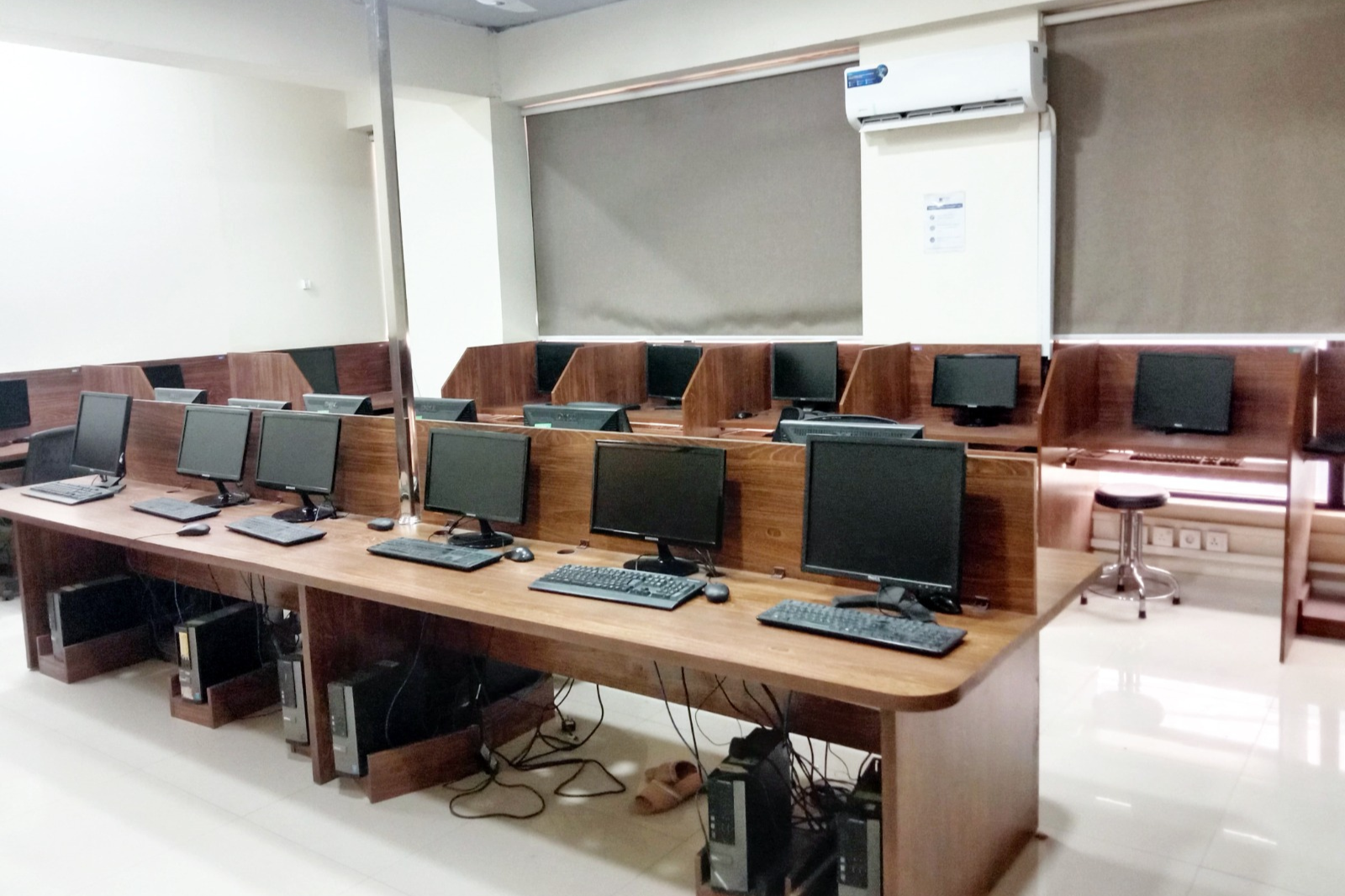 Modern computer lab at KIHS featuring desktop workstations and ergonomic seating