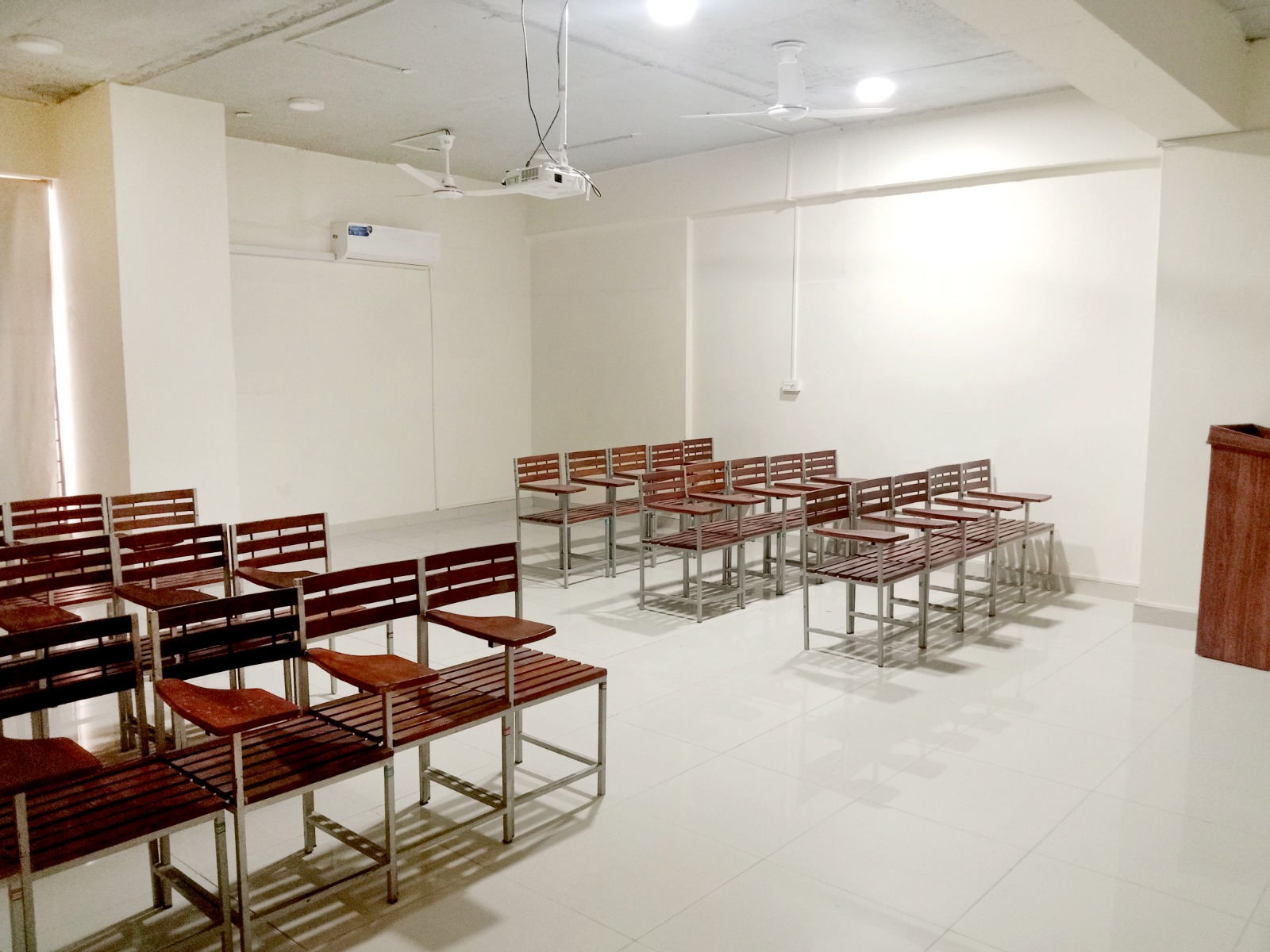 campus facilities in KIHS-Well-lit, ventilated classroom featuring arranged chairs