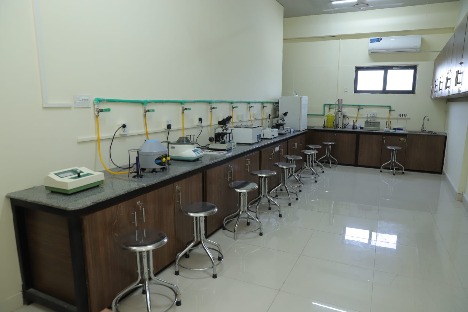 Campus facilities in KIHS: diagnostic lab featuring medical analysers and testing instruments.