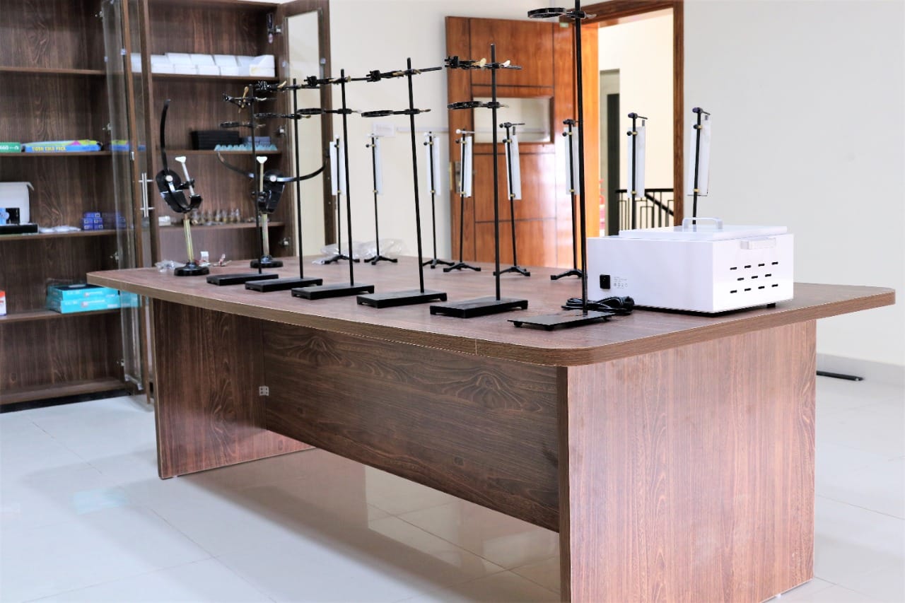Campus facilities in KIHS: science lab featuring lab apparatus on table for student experiments.